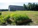 A garden and spacious backyard lead up to this single-story home at 205 Spring Creek Dr, Mount Holly, NC 28120