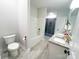 Bright bathroom with a shower, separate tub, double sinks with granite countertops, and tiled floors at 205 Spring Creek Dr, Mount Holly, NC 28120