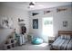 Bright bedroom featuring sporty decor, ceiling fan, and natural light from a large window at 205 Spring Creek Dr, Mount Holly, NC 28120