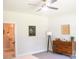 Bedroom includes modern ceiling fan, dresser, artwork, and an ensuite bathroom for added convenience at 205 Spring Creek Dr, Mount Holly, NC 28120
