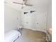 Neutral bedroom with closet, ceiling fan, and pink table set at 205 Spring Creek Dr, Mount Holly, NC 28120