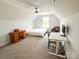 Spacious bedroom under sloped ceiling, featuring desk, chair, bed and ample natural light at 205 Spring Creek Dr, Mount Holly, NC 28120