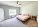 Bright bedroom featuring shiplap wall, window, ceiling fan, and neutral tones for a relaxing atmosphere at 205 Spring Creek Dr, Mount Holly, NC 28120