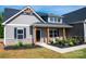 Inviting front porch with seating and tasteful landscaping offers a cozy welcome at 205 Spring Creek Dr, Mount Holly, NC 28120