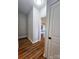 Hallway leading to kitchen featuring hardwood floors and a glimpse of the kitchen island at 205 Spring Creek Dr, Mount Holly, NC 28120