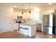 The bright, open kitchen features stainless steel appliances and a functional island at 205 Spring Creek Dr, Mount Holly, NC 28120
