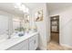 Bright bathroom with double sinks, quartz countertops, and an adjacent walk-in closet at 221 Brenett Francis Ct, Charlotte, NC 28214