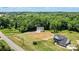 An aerial view showcases this home and its large lot bordered with mature trees in a quiet neighborhood at 237 Mariposa Rd, Stanley, NC 28164