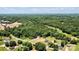 An aerial view of a sprawling lot surrounded by lush greenery, showcasing the neighborhood and stunning property at 237 Mariposa Rd, Stanley, NC 28164