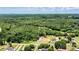 An aerial view of a wooded lot with a charming house nestled among lush trees and greenery at 237 Mariposa Rd, Stanley, NC 28164