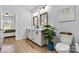 Bright bathroom with double vanity, framed mirrors, and decorative accents create a welcoming and stylish space at 237 Mariposa Rd, Stanley, NC 28164