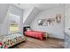 Sun-filled bedroom with matching beds under angled ceiling and window at 237 Mariposa Rd, Stanley, NC 28164