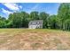 A beautiful two-story home with a two-car garage, set against a backdrop of lush greenery and a grassy lawn at 237 Mariposa Rd, Stanley, NC 28164