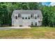 A beautiful two-story home with a two-car garage, set against a backdrop of lush greenery and a manicured lawn at 237 Mariposa Rd, Stanley, NC 28164