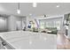 Open concept kitchen boasts a large island and seamless flow into the living area with fireplace at 237 Mariposa Rd, Stanley, NC 28164