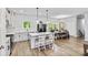 Bright open kitchen with eat-in island, stainless steel appliances, adjacent dining and wood floors at 237 Mariposa Rd, Stanley, NC 28164