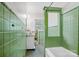 Retro bathroom with green tile, vintage fixtures, and patterned flooring at 2417 Statesville Blvd, Salisbury, NC 28147