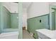 Vintage green tile bathroom featuring retro fixtures and mosaic tile flooring at 2417 Statesville Blvd, Salisbury, NC 28147