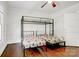 Shared bedroom featuring hardwood floors, a bunk bed with ladder and windows for ample light at 2417 Statesville Blvd, Salisbury, NC 28147