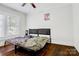 A cozy bedroom with hardwood floors, a double bed and soft, natural lighting at 2417 Statesville Blvd, Salisbury, NC 28147