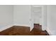 A simple bedroom with wood floors, a closet, and view to a walk-in closet at 2417 Statesville Blvd, Salisbury, NC 28147