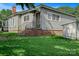 Charming single-story home featuring a brick foundation, gray siding, and a covered entryway at 2417 Statesville Blvd, Salisbury, NC 28147