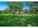 Wide-open lawn with mature trees surrounding a charming home with ample yard space at 2417 Statesville Blvd, Salisbury, NC 28147