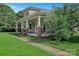 Classic home featuring a spacious front porch with stately columns and lush landscaping at 2417 Statesville Blvd, Salisbury, NC 28147