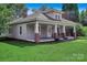 Inviting home with a covered front porch supported by classic columns and a well-maintained lawn at 2417 Statesville Blvd, Salisbury, NC 28147