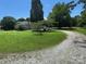 A charming single-story home sits on a large lot with a long driveway leading to the front at 2417 Statesville Blvd, Salisbury, NC 28147