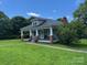 A charming single story home featuring a covered porch and a well maintained lawn at 2417 Statesville Blvd, Salisbury, NC 28147