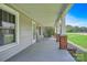 Inviting front porch with classic brick and column accents and a seating area, perfect for relaxing at 2417 Statesville Blvd, Salisbury, NC 28147
