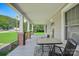 Inviting front porch with classic brick and column accents, perfect for enjoying the outdoors at 2417 Statesville Blvd, Salisbury, NC 28147