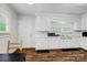 White cabinets, stainless steel sink, and wood laminate floors accent this kitchen at 2417 Statesville Blvd, Salisbury, NC 28147