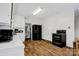 Well-lit kitchen featuring laminate wood flooring, black appliances, and white cabinets at 2417 Statesville Blvd, Salisbury, NC 28147