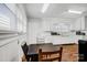 Laminate wood flooring, white cabinets, and bright natural lighting make up this kitchen at 2417 Statesville Blvd, Salisbury, NC 28147