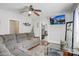 Comfortable living room with plush grey sofa, ceiling fan, and mounted TV, perfect for relaxation at 2417 Statesville Blvd, Salisbury, NC 28147