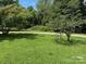 Landscaped yard with green grass and flowering trees adds charm to this rural property at 2417 Statesville Blvd, Salisbury, NC 28147