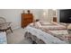 Bedroom featuring a large bed with patterned quilt and vintage wooden dresser at 24604 Blue Heron Cir, Lancaster, SC 29720