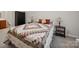 Cozy bedroom featuring a large bed, dark armoire and matching side tables at 24604 Blue Heron Cir, Lancaster, SC 29720