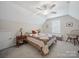 Bedroom featuring sloped ceilings, ceiling fan and large bed with patterned quilt at 24604 Blue Heron Cir, Lancaster, SC 29720