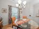Dining room with round glass table, orange upholstered chairs, and chandelier lighting at 24604 Blue Heron Cir, Lancaster, SC 29720