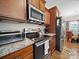 Gourmet kitchen with granite countertops, stainless steel appliances including range, microwave, and refrigerator at 24604 Blue Heron Cir, Lancaster, SC 29720