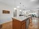 Open kitchen boasts a large island, granite countertops, stainless steel appliances, and hardwood floors at 24604 Blue Heron Cir, Lancaster, SC 29720