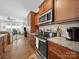 Bright kitchen featuring stainless steel appliances, granite counters, ample storage in wooden cabinets and hardwood floors at 24604 Blue Heron Cir, Lancaster, SC 29720