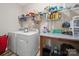 Organized laundry room features a washer, dryer, storage shelves and utility table at 24604 Blue Heron Cir, Lancaster, SC 29720