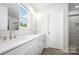 Bright bathroom with double vanity, modern fixtures, and a window with a view at 3001 Sadler Woods Ln, Charlotte, NC 28214