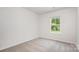 Carpeted bedroom with a window overlooking trees at 3001 Sadler Woods Ln, Charlotte, NC 28214