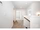 Hallway with neutral carpet and open doorways at 3001 Sadler Woods Ln, Charlotte, NC 28214