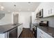 Contemporary kitchen featuring stainless steel appliances, gray countertops, and stylish white cabinetry at 3001 Sadler Woods Ln, Charlotte, NC 28214